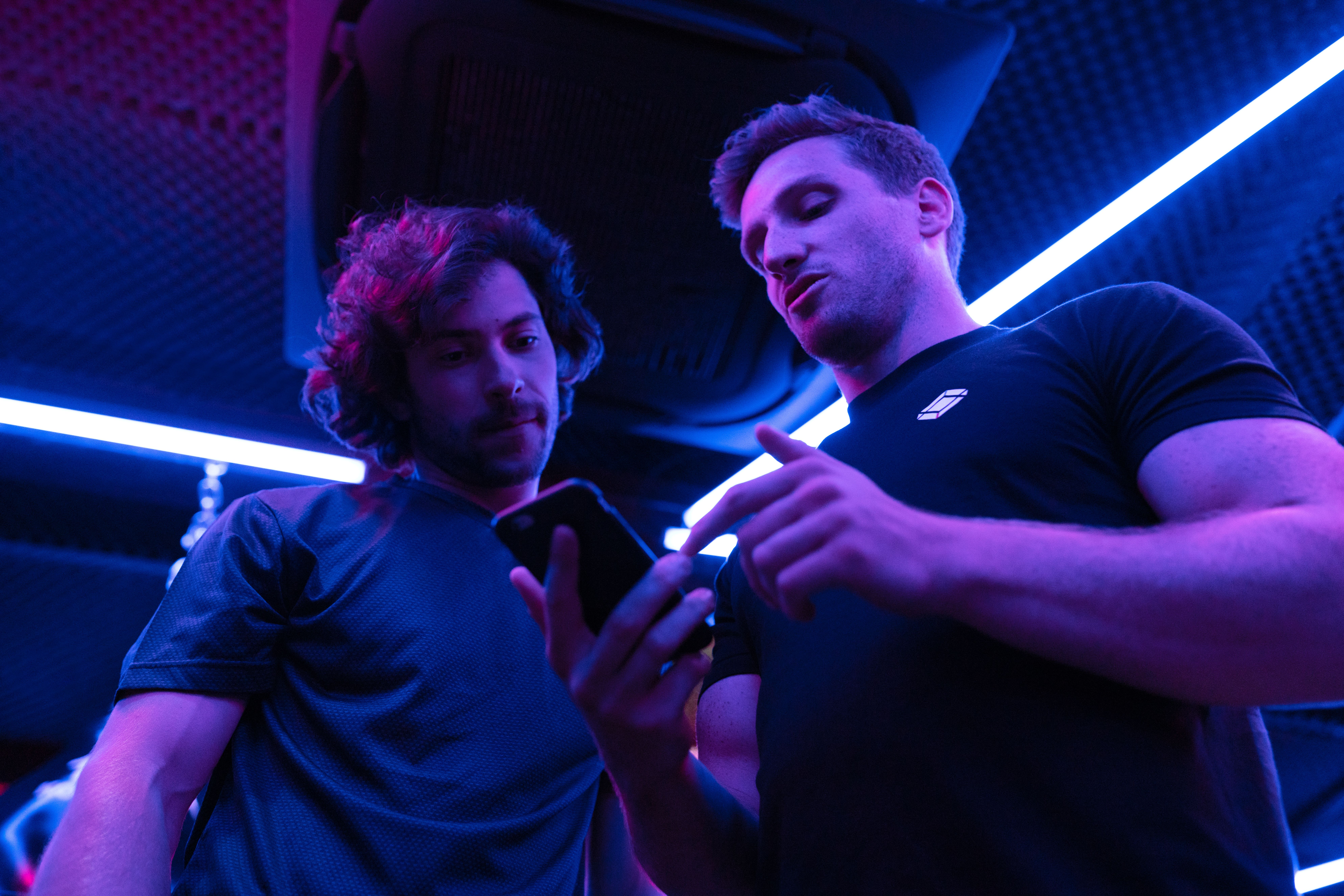 Coach reviewing a training plan on their phone with an athlete