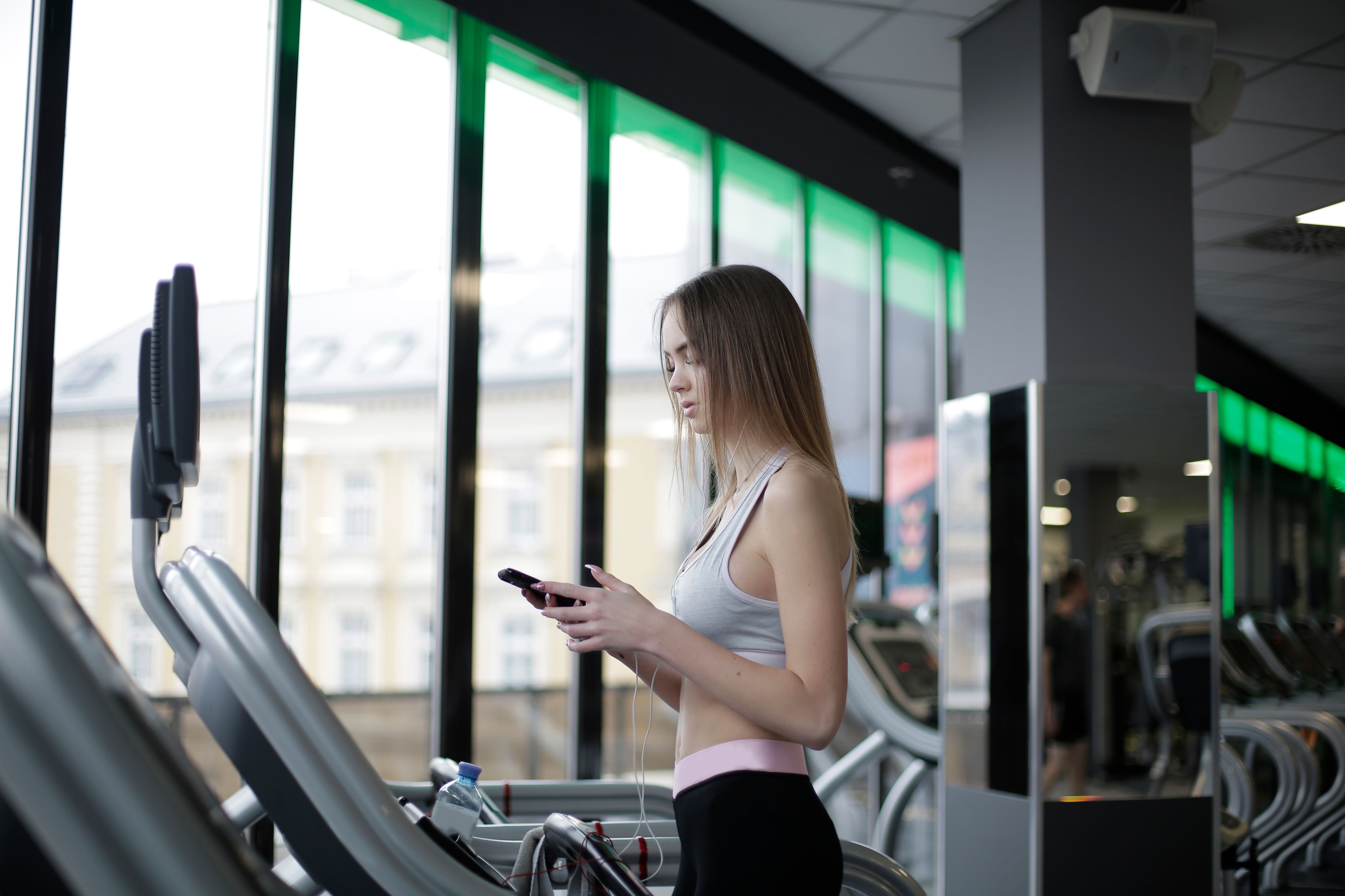 Woman walking with phone after training